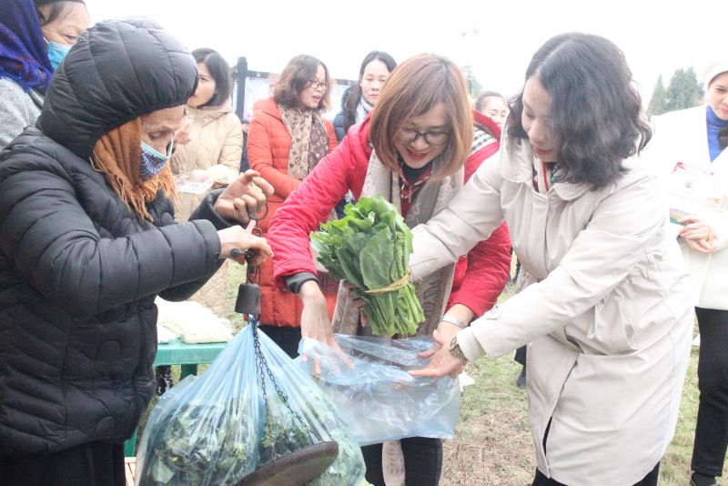 Các đại biểu và du khách tham quan, mua sắm các sản vật của địa phương tại hội chợ