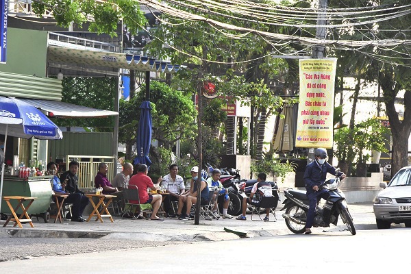 Một quán cà phê “cóc” vỉa hè đường Nguyễn Thị Minh Khai vẫn bán hàng. Khi được hỏi, chủ quán nói: “Cả nhà em trông vào quán này, không bán ngày nào treo niêu ngày đó, nhưng em cố gắng khống chế dưới 10 người…”.