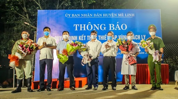 Ban chỉ đạo phòng chống dịch Covid-19 huyện Mê Linh tặng hoa và chụp hình lưu niệm sau khi kết thúc cách ly y tế đối với thôn Hạ Lôi