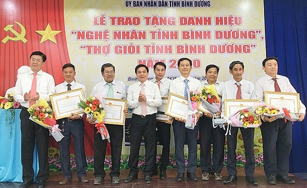 Ông Nguyễn Thanh Trúc - Phó Chủ tịch UBND Bình Dương (bên trái), trao tặng bằng công nhận danh hiệu “Nghệ nhân tỉnh Bình Dương” năm 2020 cho các nghệ nhân. Ảnh Thoại Phương.