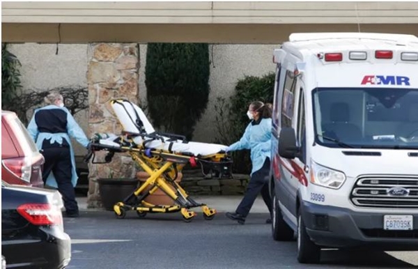 Nhân viên y tế chuẩn bị chuyển bệnh nhân nhiễm Covid-19 lên xe cứu thương tại Kirkland, bang Washington, Mỹ
