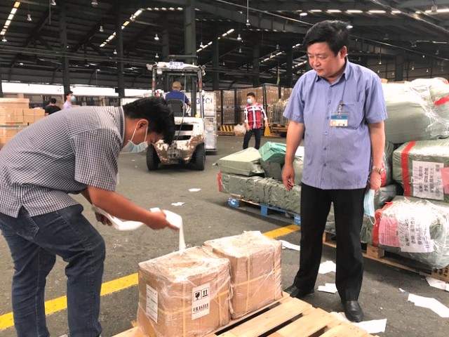 Ông Ngô Quang Chiến, Bí thư Huyện ủy Cam Lộ (phải) kiểm tra việc đóng gói hàng để gửi đi Mỹ