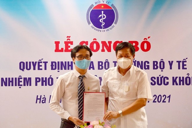Thứ trưởng Bộ Y tế Đỗ Xuân Tuyên (bìa phải) trao quyết định bổ nhiệm Phó Tổng biên tập Báo Sức khỏe và Đời sống Nguyễn Ngọc Đức (bìa trái)