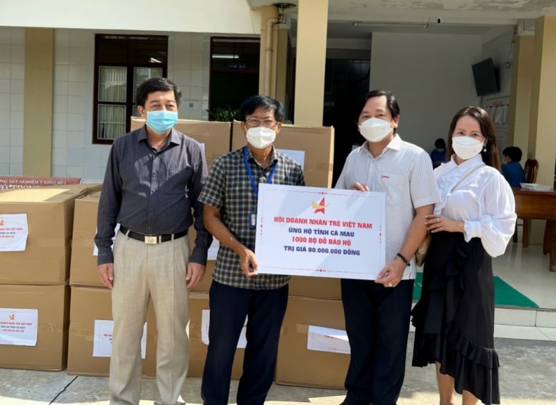 Đại diện Hội Doanh nhân trẻ Cà Mau (thứ 2, từ phải sang) nhận ủy quyền của Hội doanh nhân trẻ Việt Nam trao tặng 1.000 bộ đồ bảo hộ y tế cho Sở Y tế tỉnh. Ảnh: KT