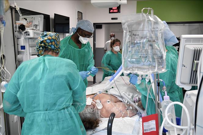 Nhân viên y tế điều trị cho bệnh nhân Covid-19 tại bệnh viện ở Paris, Pháp (Ảnh: AFP/TTXVN)