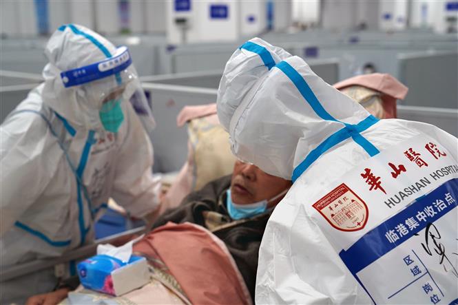 Nhân viên y tế điều trị cho bệnh nhân Covid-19 tại bệnh viện dã chiến ở Thượng Hải, Trung Quốc, ngày 23/04/2022 (Ảnh: THX/ TTXVN)