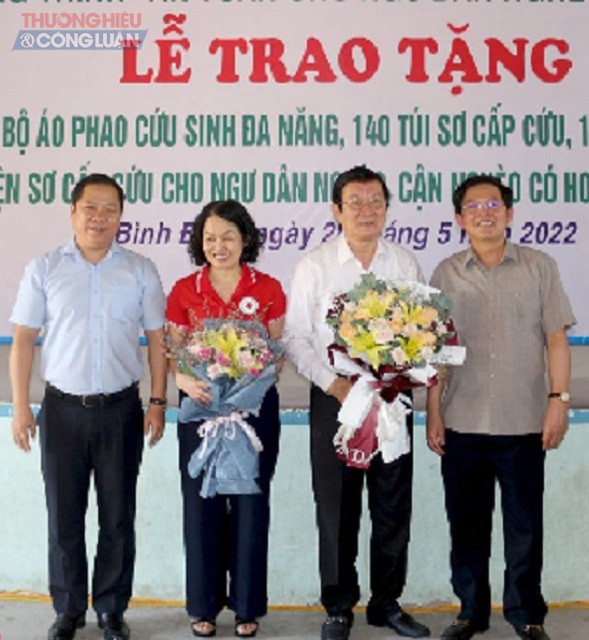 Các đồng chí Hồ Quốc Dũng (bìa phải) và Nguyễn Phi Long (bìa trái) tặng hoa, cảm ơn các đồng chí Trương Tấn Sang và Bùi Thị Hòa.