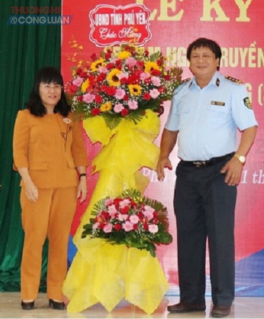 Bà Hồ Thị Nguyên Thảo (bên trái) trao tặng lẵng hoa của UBND tỉnh Phú Yên cho đại diện lãnh đạo Cục QLTT Phú Yên nhân kỷ niệm 65 năm Ngày truyền thống lực lượng QLTT.