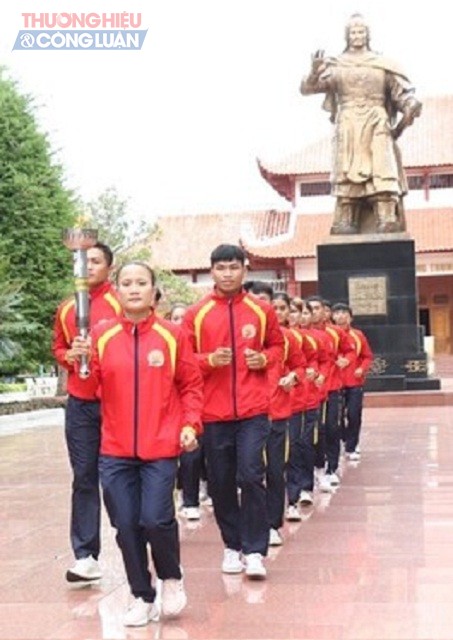 VĐVNguyễn Thị Hằng Nga (đứng trước) cùng đoàn VĐV xuất sắc thực hiện nghi thức rước đuốc thiêng từ Bảo tàng Quang Trung.