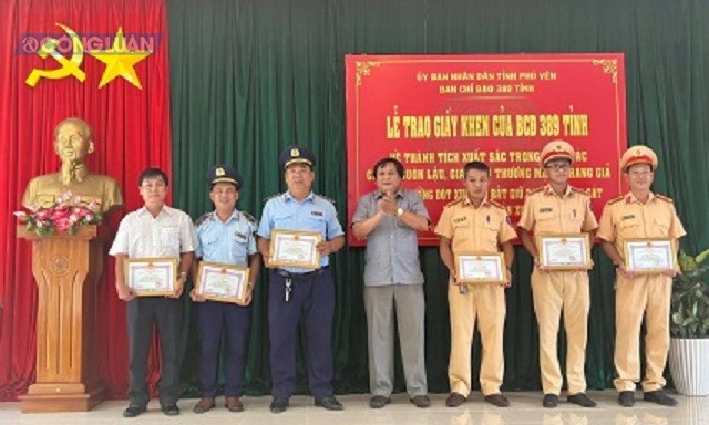 Ông Huỳnh Trang, Phó Ban Thường trực Ban Chỉ đạo 389 tỉnh Phú Yên, Cục trưởng Cục QLTT tỉnh (đứng giữa) trao giấy khen cho các tập thể, cá nhân.