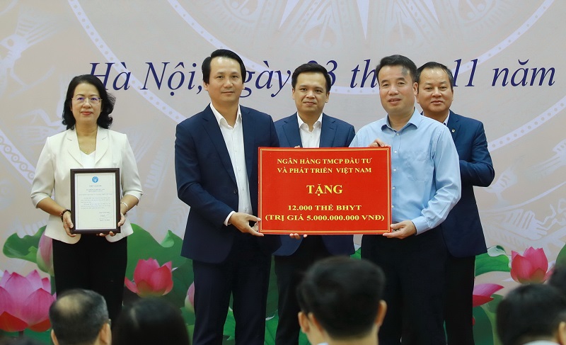 Ông Trần Long - Phó TGĐ BIDV (bên trái) đại diện ngân hàng trao tặng 12.000 thẻ BHYT trị giá 05 tỷ đồng