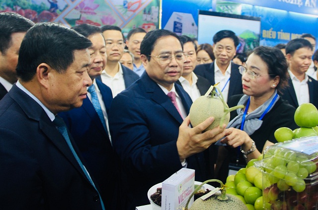 Thủ tướng Chính phủ Phạm Minh Chính tham quan một gian hàng giới thiệu sản phẩm nông sản đặc trưng.