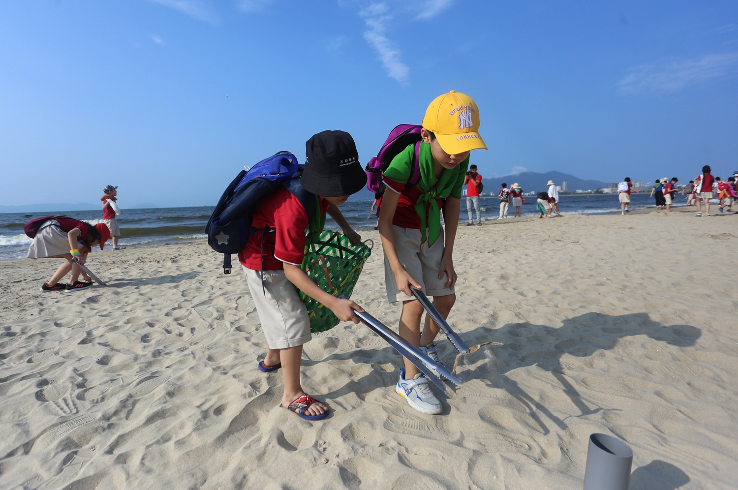 Các em nhỏ hào hứng nhặt rác làm sạch bãi biển.