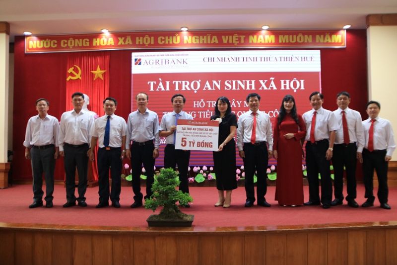 Bà Phùng Thị Bình, Phó Tổng Giám đốc Agribank trao bảng tượng trưng tài trợ xây dựng trường Tiểu học cho Đại diện lãnh đạo UBND tỉnh Thừa thiên Huế
