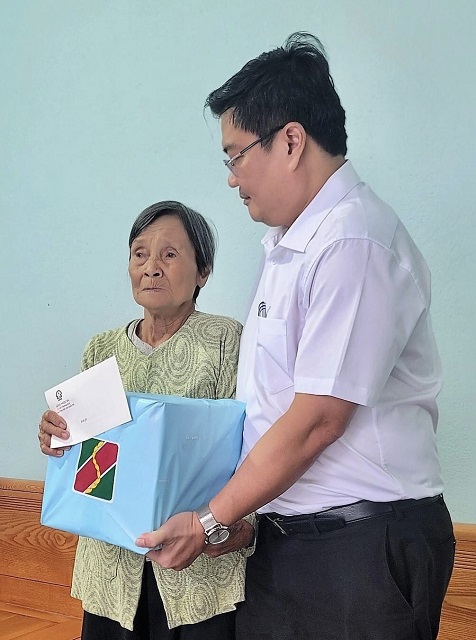 Ông Nguyễn Hoàng Hải trao quà cho bà Đặng Thị Bốn.