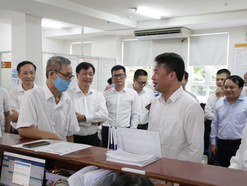 Tổng Giám đốc Bảo hiểm xã hội Việt Nam Nguyễn Thế Mạnh trao đổi với người dân đến làm việc
