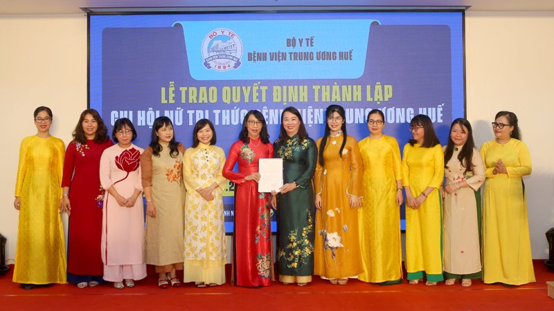 Bà Nguyễn Thị Ái Vân- Chủ tịch Hội Nữ Trí thức Tỉnh Thừa Thiên Huế (mặc áo dài sẫm ở giữa) trao quyết định thành lập