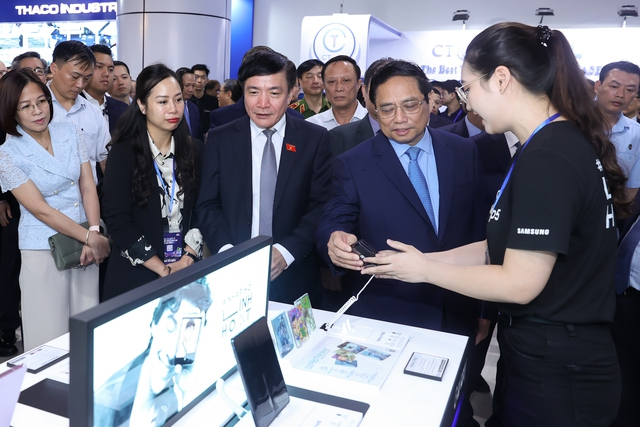 Thủ tướng Phạm Minh Chính cùng các đại biểu tham quan gian hàng trưng bày sản phẩm đổi mới sáng tạo của các doanh nghiệp - Ảnh: VGP/Nhật Bắc
