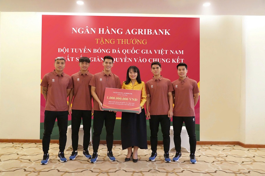 Ảnh 2: Bà Phùng Thị Bình - Phó Tổng Giám đốc Agribank trao thưởng 1 tỷ đồng cho đại diện Đội tuyển Bóng đá Quốc gia Việt Nam