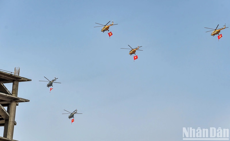 Các trực thăng Mi-8 và Mi-17 mang theo cờ Đảng, cờ Tổ quốc hướng tới lễ đài