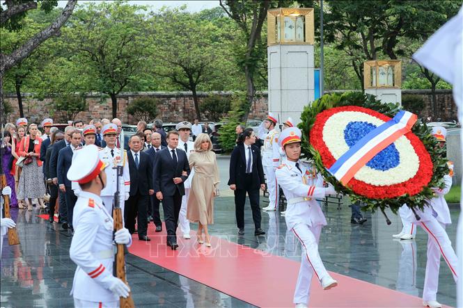 Tổng thống Pháp Emmanuel Macron và Phu nhân đến đặt vòng hoa tại Đài tưởng niệm các Anh hùng liệt sĩ. Ảnh: An Đăng/TTXVN