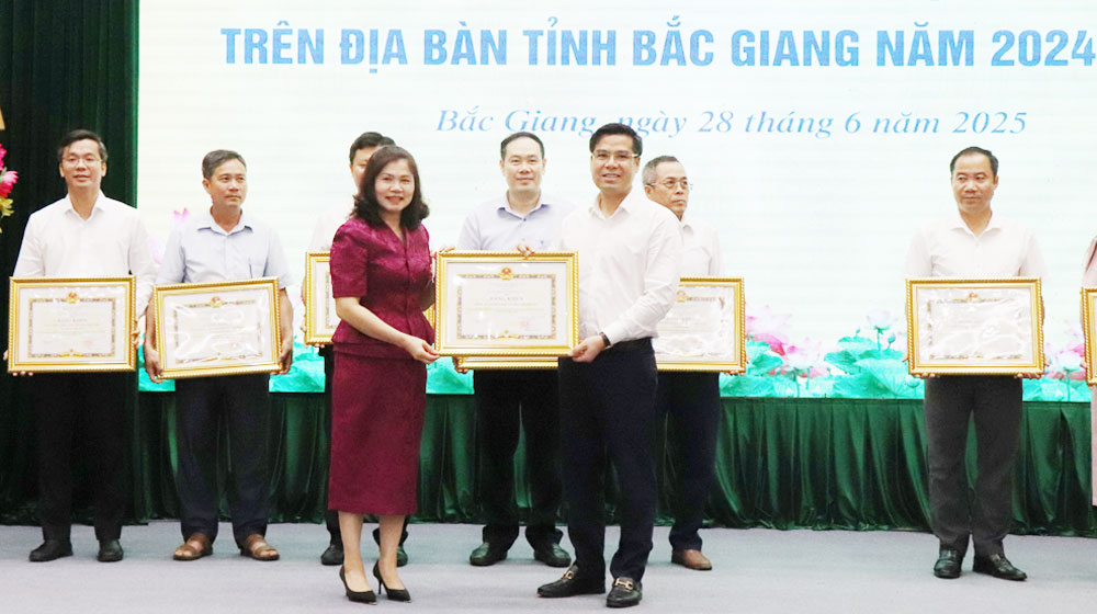 Đồng chí Lâm Thị Hương Thành trao Bằng khen của Chủ tịch UBND tỉnh cho các cá nhân có thành tích xuất sắc trong triển khai thực hiện Chương trình xóa nhà tạm, nhà dột nát trên địa bàn tỉnh.
