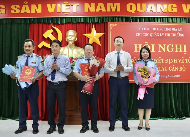 Ông Dương Minh Đức (thứ 2 từ trái qua) và ông Võ Mai Hưng (thứ 2 từ phải qua) trao quyết định bổ nhiệm các chức danh Chi cục trưởng và Phó chi cục trưởng Chi cục QLTT tỉnh Gia Lai cho các cán bộ. Ảnh: Nh-Hiền