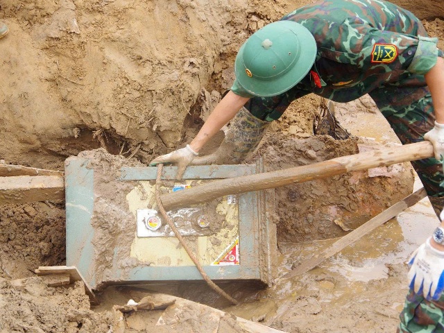 Lực lượng chức năng tìm thấy két sắt của người dân bị vùi lấp trong quá trình dọn dẹp, khắc phục hậu quả.