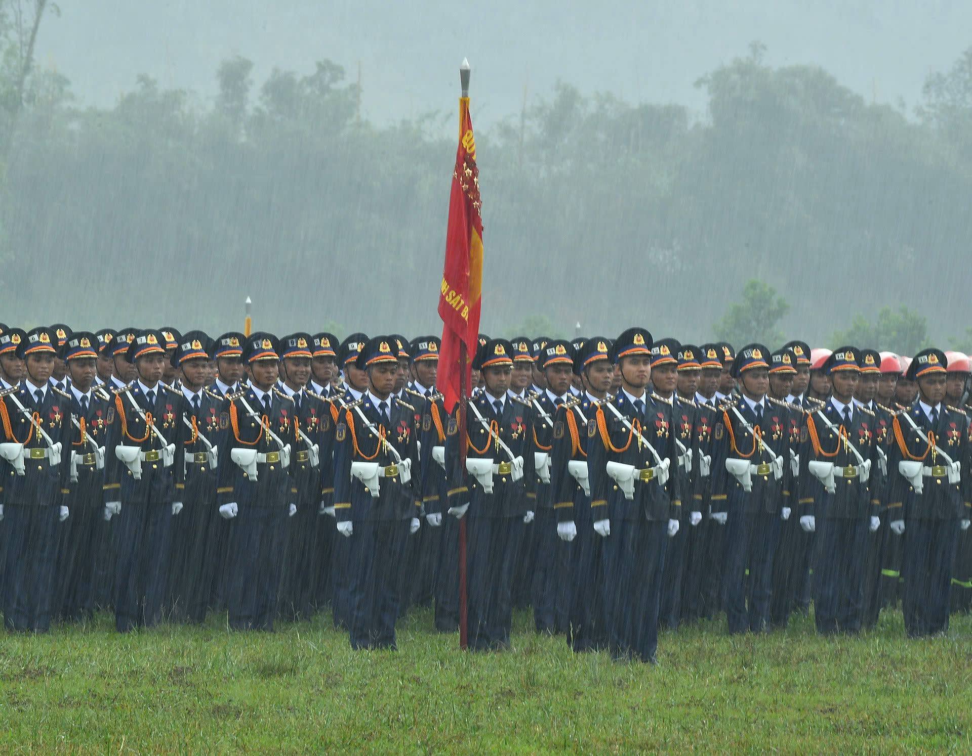 Khối đứng sĩ quan Cảnh sát biển Việt Nam hàng ngũ nghiêm trang, chỉnh tề dù trời đổ mưa nặng hạt.