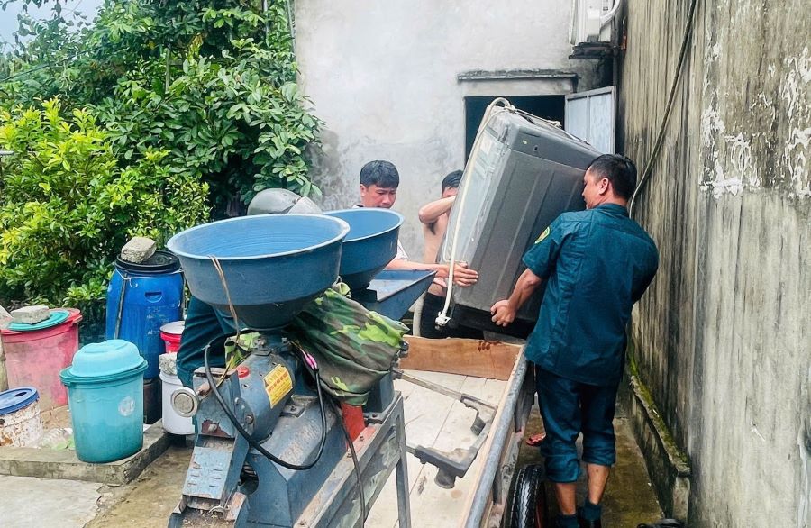 Lực lượng chức năng hỗ trợ người dân xã Đan Hải di dời tài sản.