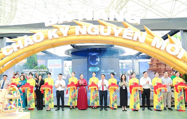 Phó Bí thư Thường trực Thành ủy Nguyễn Đình Vĩnh (thứ 8, bên phải sang) và Phó Chủ tịch UBND thành phố Nguyễn Thị Anh Thi (thứ 10, bên phải sang) cắt băng khai mạc gian trưng bày “Đà Nẵng - Chào kỷ nguyên mới” tại triển lãm.