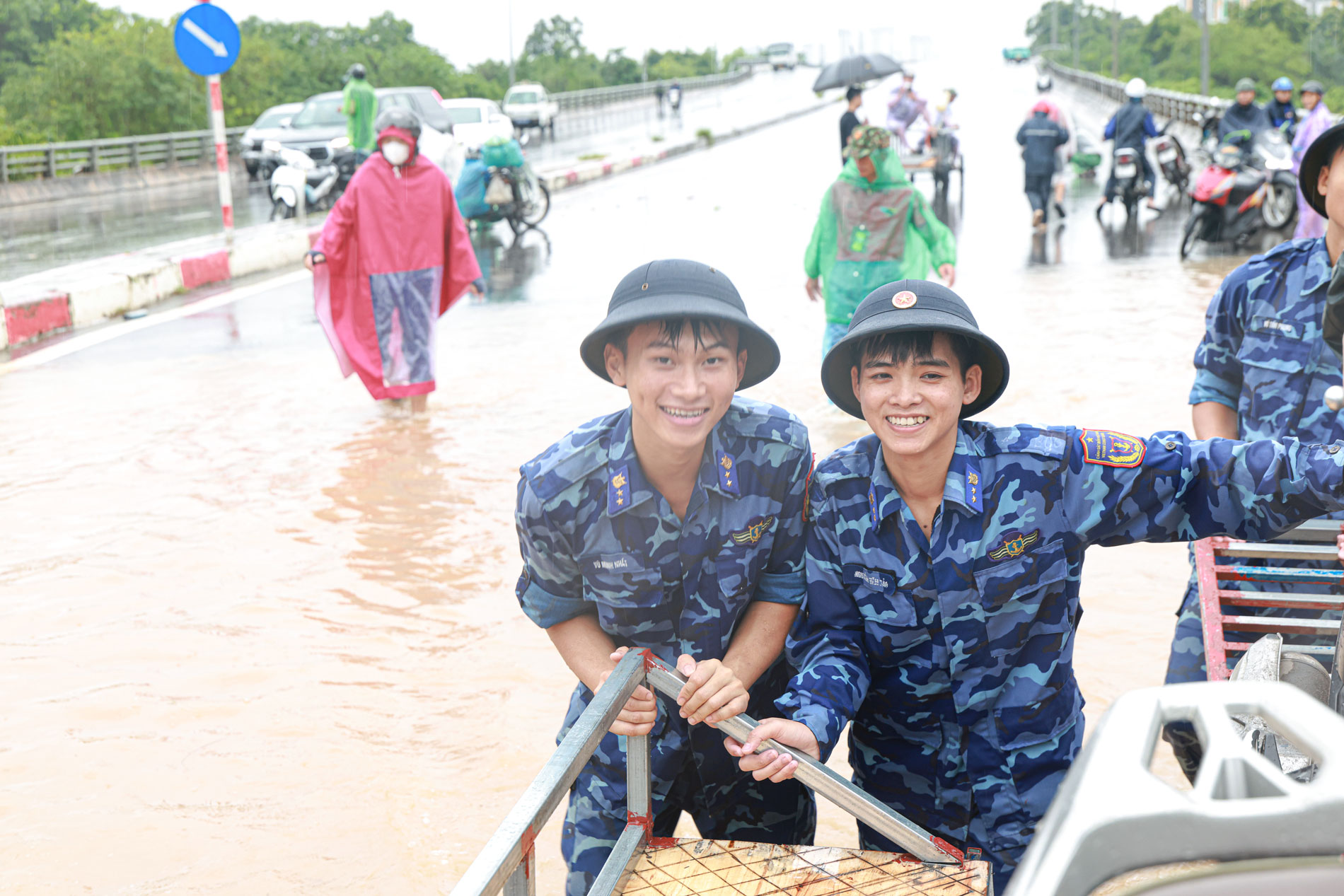 Dù mưa táp vào mặt nhưng nụ cười vẫn nở trên môi khi được giúp người dân. Dù mưa táp vào mặt nhưng nụ cười vẫn nở trên môi khi được giúp người dân.