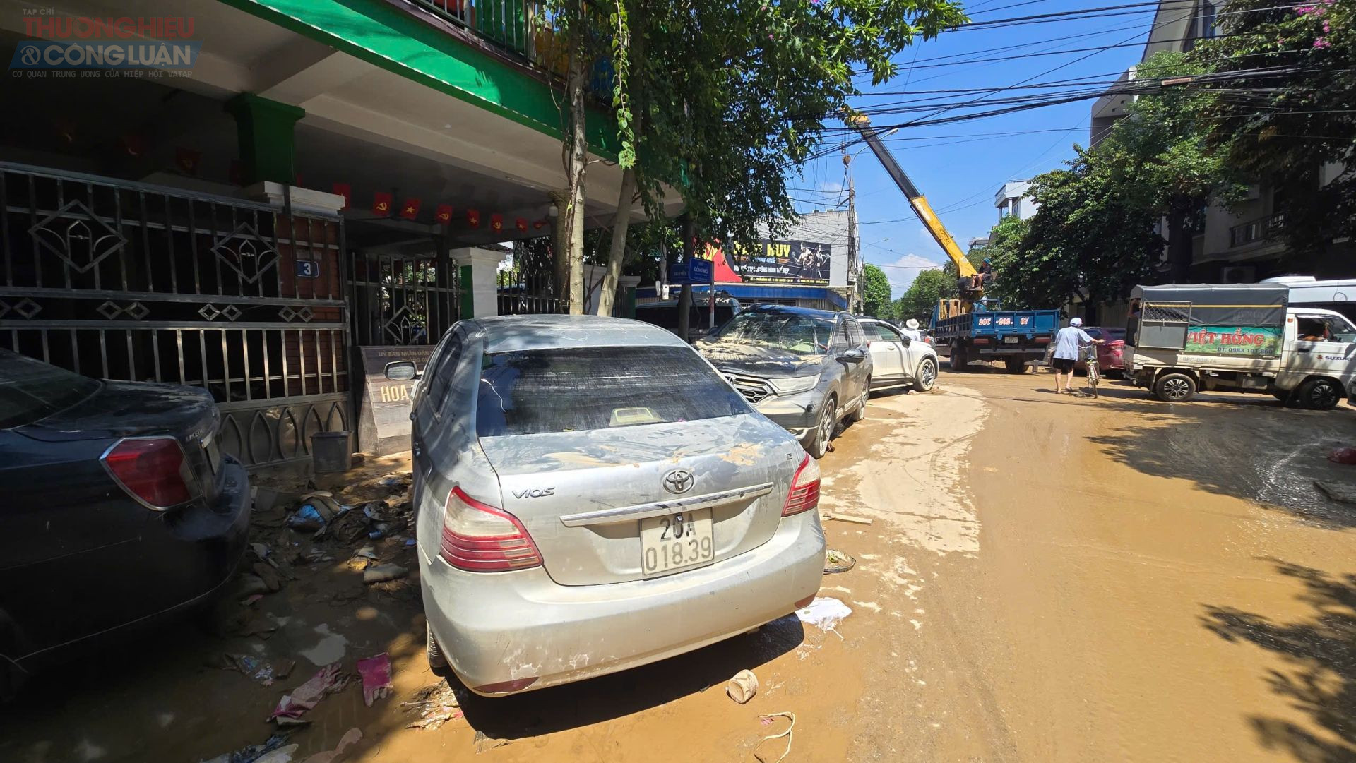 Những chiếc ô tô lấm lem bùn đất nằm im lìm bên lề phố – chứng nhân câm lặng của trận lũ dữ vừa tràn qua, để lại vệt thương tích dài trên thành phố vốn yên bình.