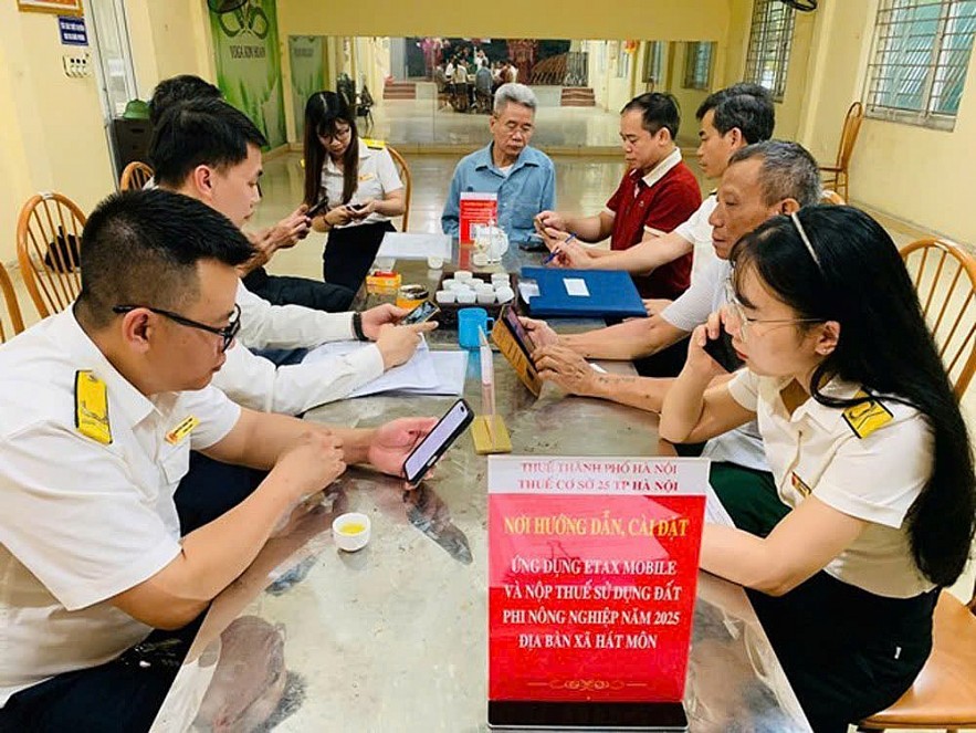 Công chức Thuế TP. Hà Nội hướng dẫn người nộp thuế khai thuế sử dụng đất phi nông nghiệp năm 2025 qua Etax Mobile. Ảnh: MP Công chức Thuế TP. Hà Nội hướng dẫn người nộp thuế khai thuế sử dụng đất phi nông nghiệp năm 2025 qua Etax Mobile. Ảnh: MP