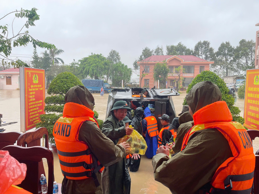 Lực lượng Quân đội vận chuyển nhu yếu phẩm ra xe thiết giáp để mang đến người dân vùng lũ còn bị cô lập.