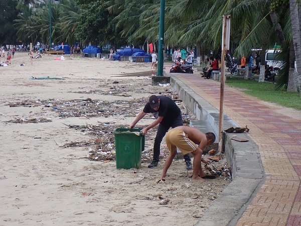 Bãi biển Hoàn Chồng i1ra61t ít rác, nhưng có những du khách nước ngoài vẫn cùng với một người địa phương đang tự nguyện ra thu rác khi cơn mưa vừa dứt