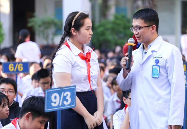 B&aacute;c sĩ trao đổi với học sinh.