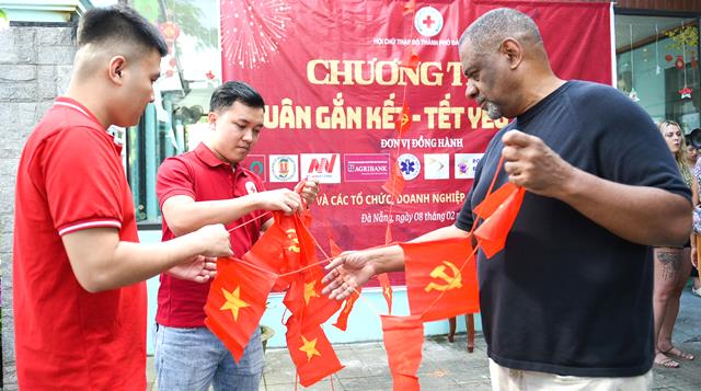 C&aacute;c t&igrave;nh nguyện vi&ecirc;n c&ugrave;ng nhau chăng cờ, treo hoa, tạo kh&ocirc;ng kh&iacute; Xu&acirc;n rực rỡ tại Trung t&acirc;m.