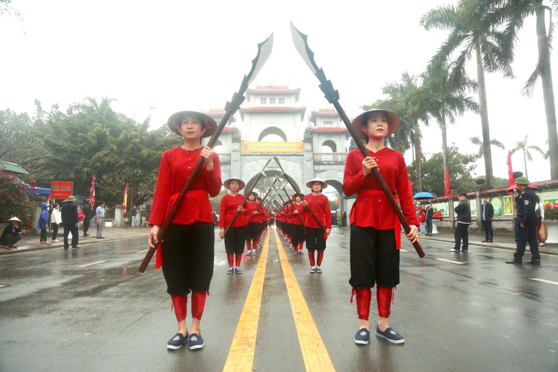 Đội h&igrave;nh rước lễ trong trang phục truyền thống diễu h&agrave;nh qua cổng đền, t&aacute;i hiện kh&ocirc;ng kh&iacute; trang nghi&ecirc;m của ng&agrave;y ch&iacute;nh hội tại M&ecirc; Linh.