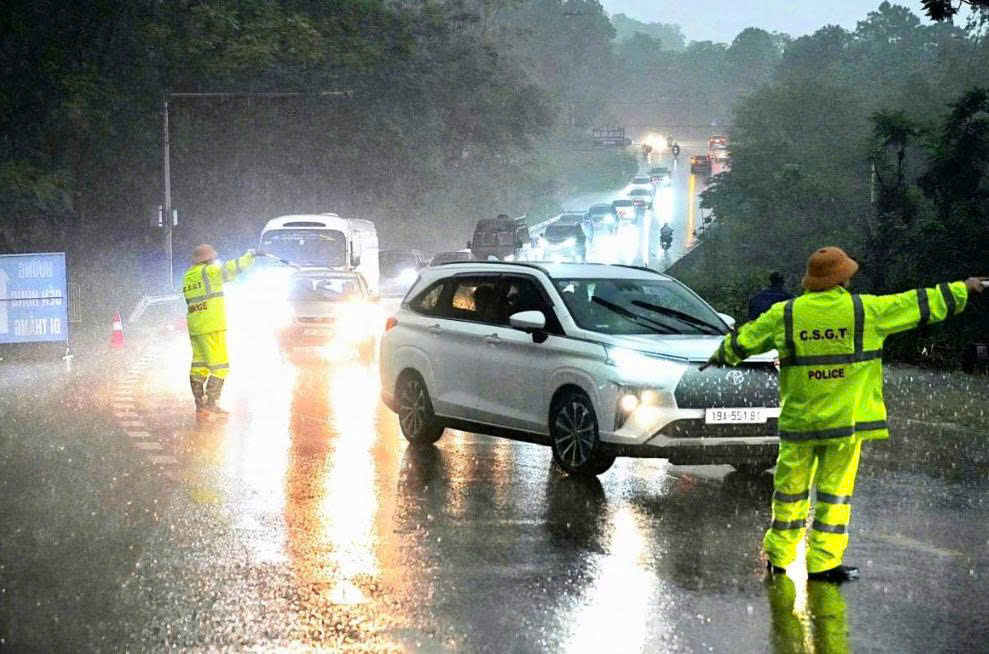 Lực lượng Cảnh s&aacute;t giao th&ocirc;ng tỉnh Ph&uacute; Thọ đội mưa ph&acirc;n luồng giao th&ocirc;ng, tạo thuận lợi cho du kh&aacute;ch về với đền H&ugrave;ng.