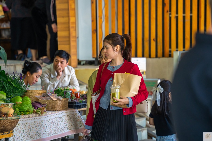 Chị Ninh Thị Hường (b&ecirc;n phải) lựa chọn rau tại Phi&ecirc;n chợ n&ocirc;ng sản hữu cơ Đ&agrave; Lạt, ưu ti&ecirc;n sản phẩm ph&ugrave; hợp cho bữa ăn gia đ&igrave;nh.