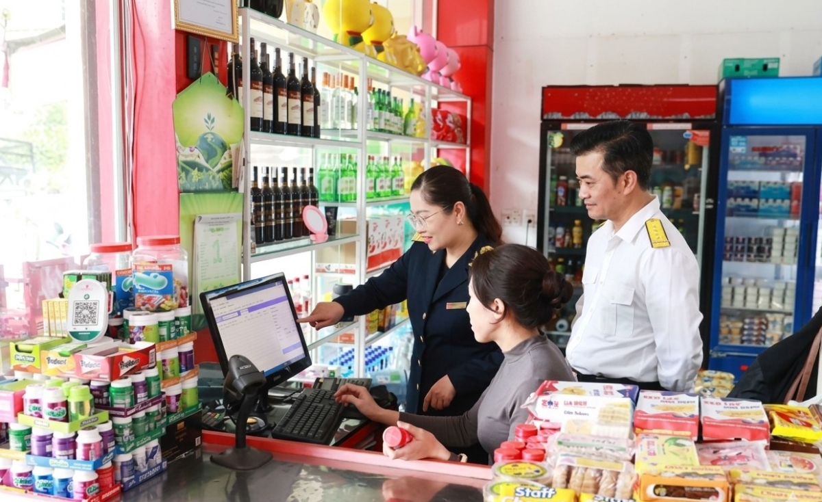 C&ocirc;ng chức Thuế tỉnh Sơn La hỗ trợ hộ kinh doanh l&agrave;m thủ tục k&ecirc; khai thuế. Ảnh: KT