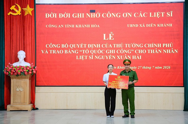 L&atilde;nh đạo C&ocirc;ng an địa phương trao qu&agrave; của C&ocirc;ng an x&atilde; cho th&acirc;n nh&acirc;n liệt sĩ Thiếu t&aacute; Nguyễn Xu&acirc;n Hải