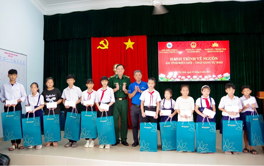 Trung t&aacute; Trần Văn Ngưu, Đồn trưởng Đồn BPCK Phước T&acirc;n v&agrave; &Ocirc;ng Nguyễn Hồng Hưng, Ph&oacute; B&iacute; thư Đảng ủy, Ph&oacute; Gi&aacute;m đốc Trung t&acirc;m huấn luyện bay Việt Nam Airline trao qu&agrave; cho c&aacute;c ch&aacute;u học sinh.