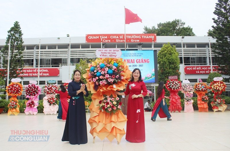 B&agrave; B&ugrave;i Thị Thu Thủy, Ph&oacute; Chủ tịch UBND phường Tam Thắng (tr&aacute;i) tặng hoa ch&uacute;c mừng Trường dịp khai giảng năm học mới