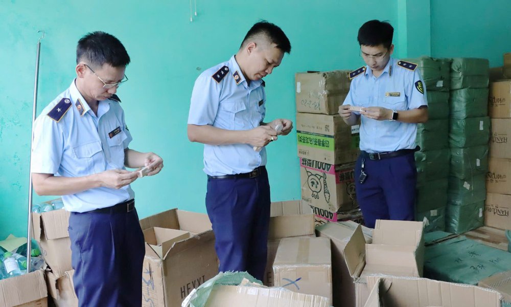 Cán bộ Quản lý thị trường kiểm tra hàng hóa vi phạm. Cán bộ Quản lý thị trường kiểm tra hàng hóa vi phạm.